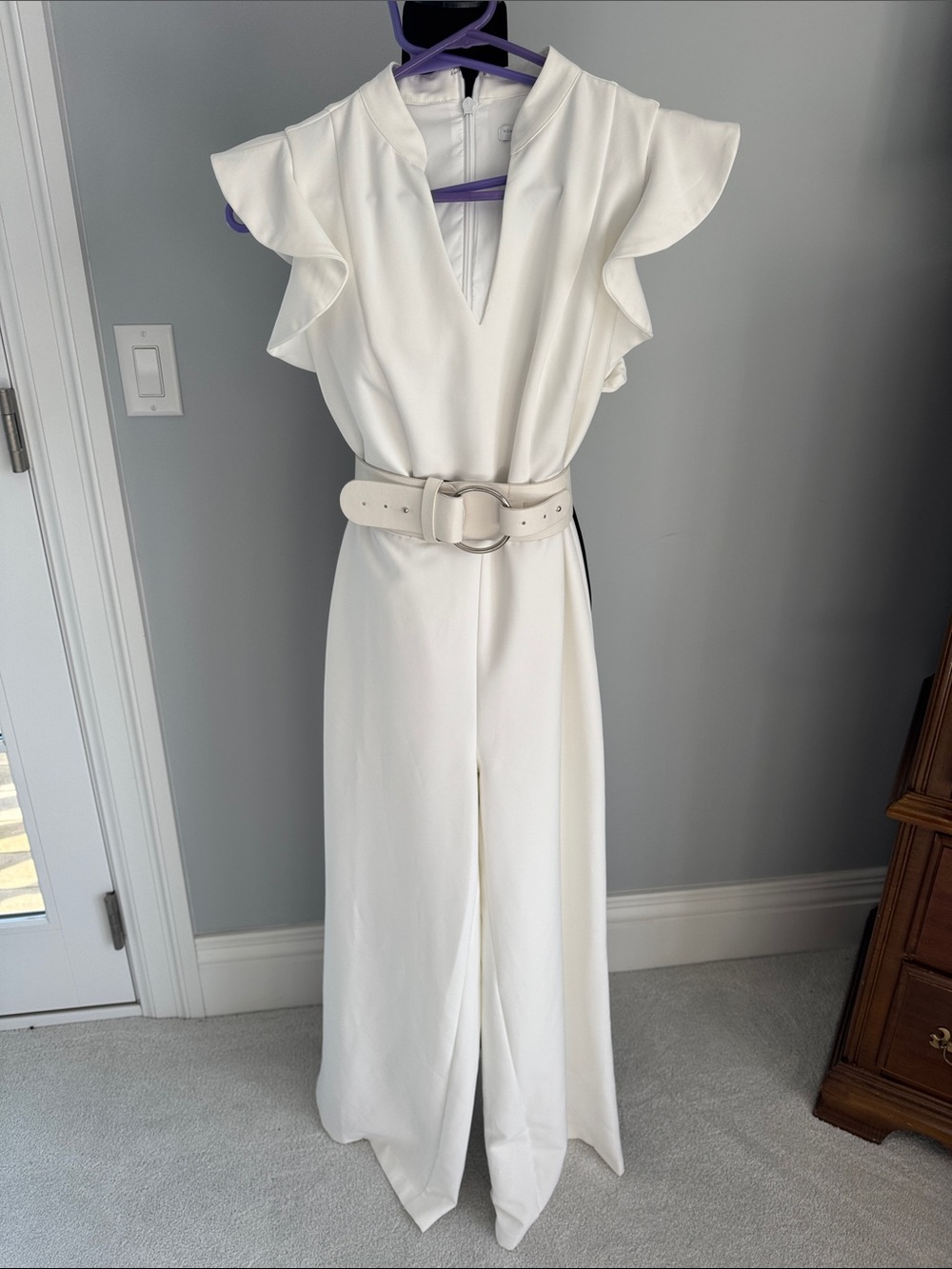 New York & Company White Flutter-Sleeve V-Neck Jumpsuit with optional belt.